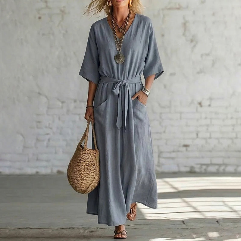 Rear view of the Isolde maxi dress in a neutral grey, illustrating the graceful drape of the breathable linen blend.