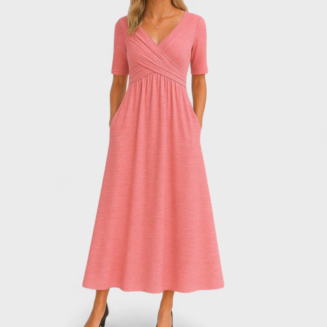 Lifestyle shot of a woman walking outdoors in the grey Lynton elegant midi dress, demonstrating its versatility and movement.