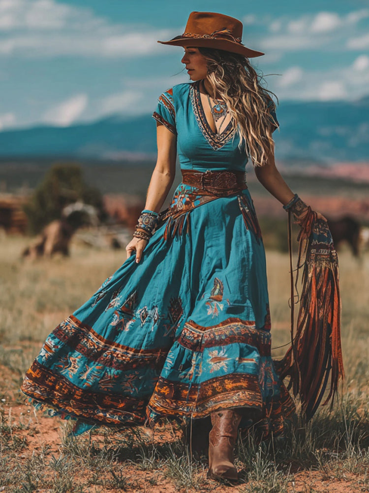 Front view of the Rhiannon bohemian western maxi dress in green, showcasing its geometric print and short sleeves.