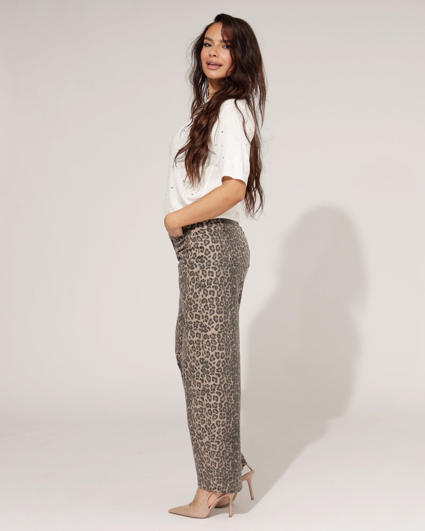 Detailed shot of the fabric and fit of the panter print barrel jeans, highlighting the relaxed leg and tapered ankle.