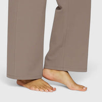 Woman pairing black Adeline pull-on trousers with a smart blouse, suitable for office wear.