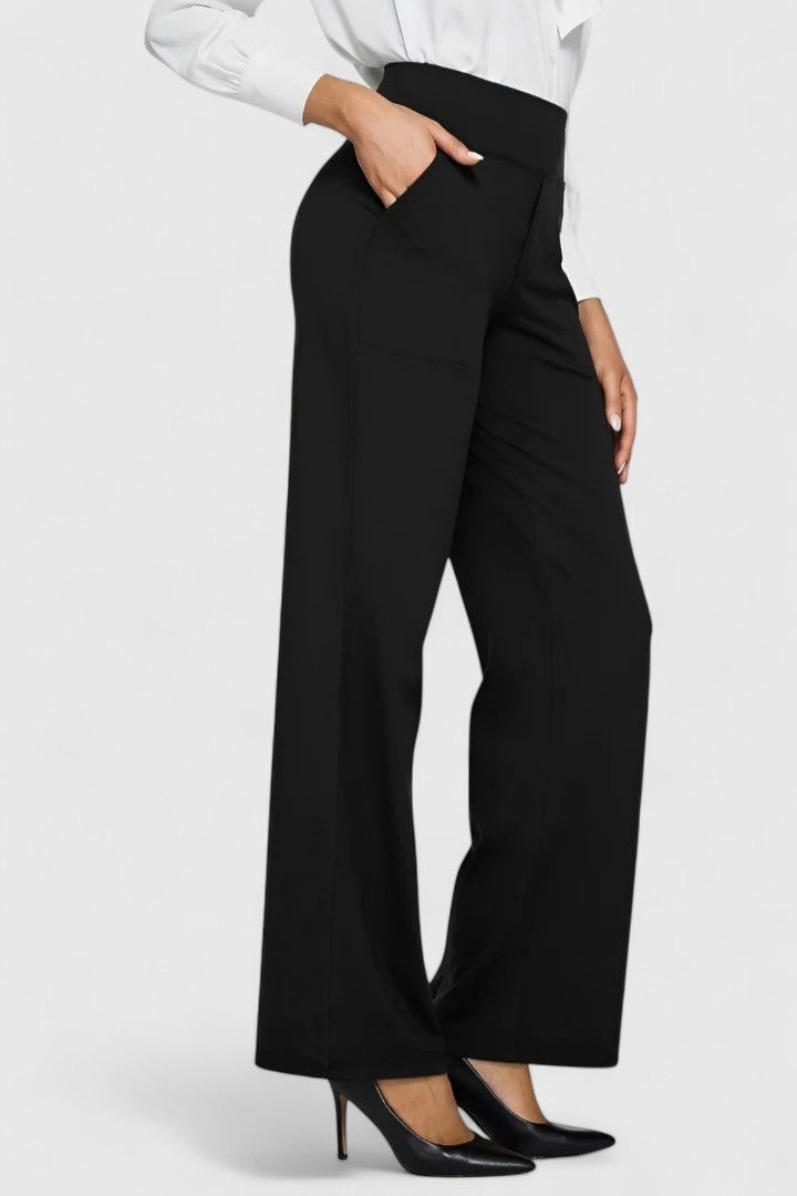 A stack of various coloured Adeline pull-on trousers, showcasing the available range.