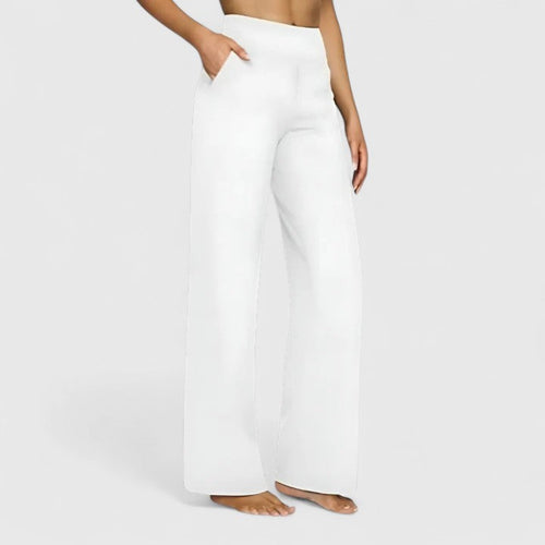 Side profile of the woman in taupe Adeline pull-on trousers, highlighting the smooth drape and comfortable waistband.