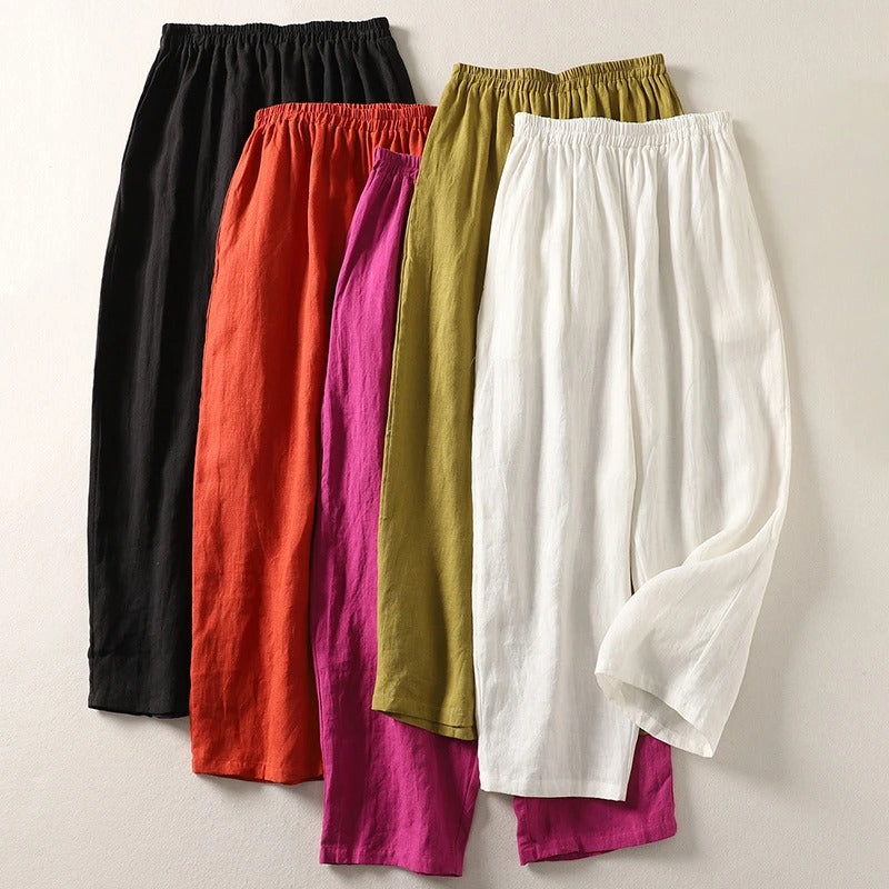Front view of Adira flowy cotton-linen trousers in a vibrant orange colour, showcasing the relaxed fit.