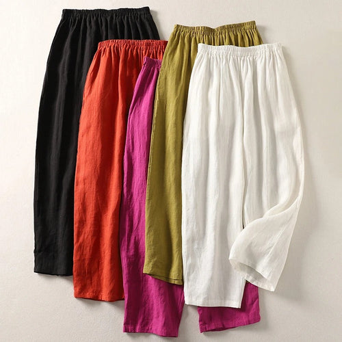 Front view of Adira flowy cotton-linen trousers in a vibrant orange colour, showcasing the relaxed fit.