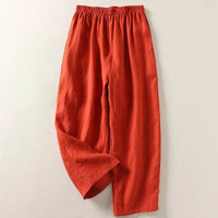 Close-up detail of the breathable cotton-linen fabric texture on the black flowy trousers.