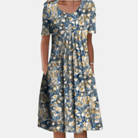 Side profile of a woman wearing the Alessia cotton tummy control dress in yellow floral, demonstrating its flattering drape.