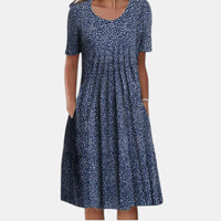 Lifestyle shot of a woman enjoying a casual outdoor setting while wearing the Alessia cotton tummy control dress in blue dots.