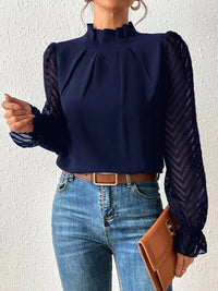 Front view of a cream ruffled mock neck blouse, showcasing the elegant neckline and sleeve detail.