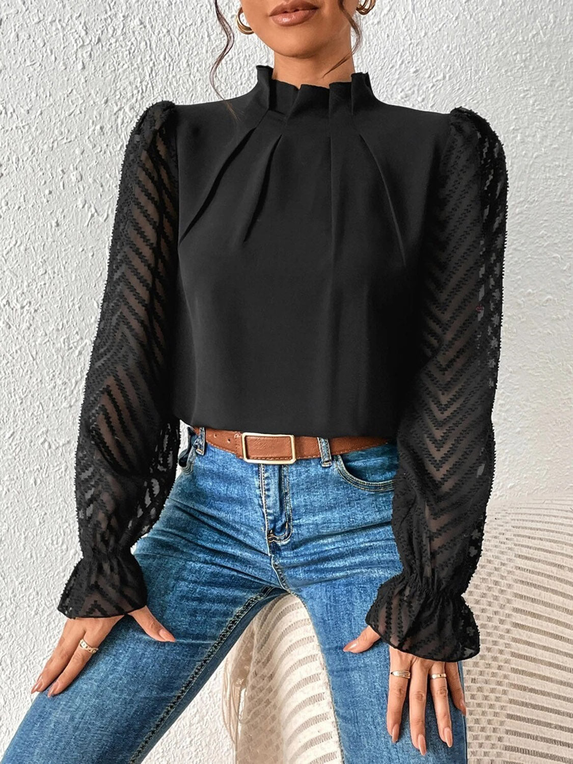 Back view of the white ruffled mock neck blouse, displaying the overall silhouette and hemline.