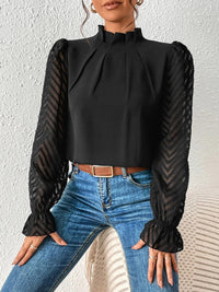 Back view of the white ruffled mock neck blouse, displaying the overall silhouette and hemline.