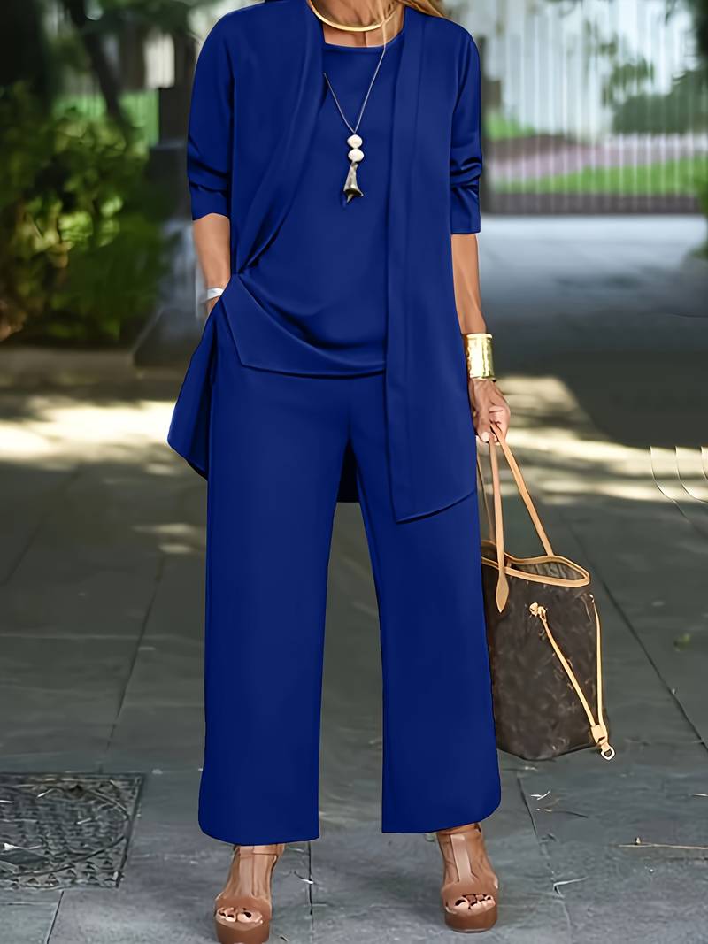 Side profile of a woman in the stylish two-piece suit, demonstrating the garment's structured silhouette.