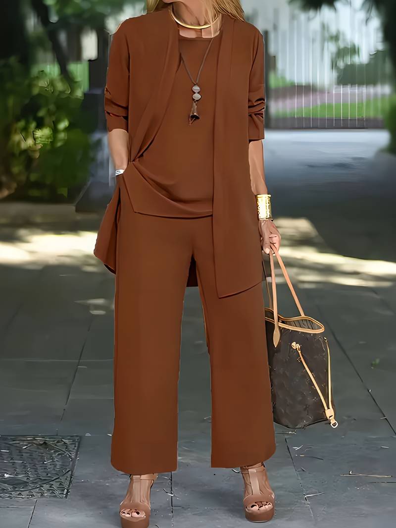 Rear view of the elegant two-piece suit, focusing on the refined cut and drape of the trousers and jacket.