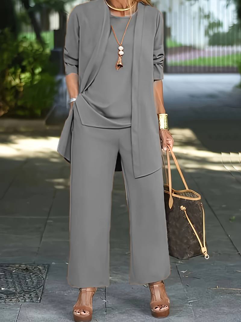 Lifestyle shot of a woman confidently walking in the two-piece suit, illustrating its movement and comfort.