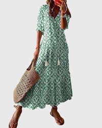 Side profile of the Anthea boho vintage summer dress, highlighting its flowing silhouette and delicate pattern.