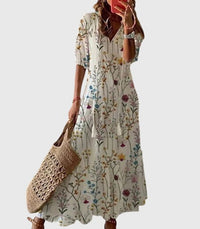 A vibrant red Anthea boho vintage summer dress displayed flat, showing the full pattern detail.