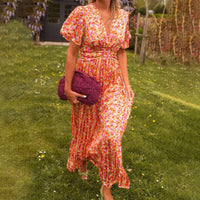 Side profile of a model wearing the green Antonia A-Line Dress, demonstrating the fluid movement of the skirt.