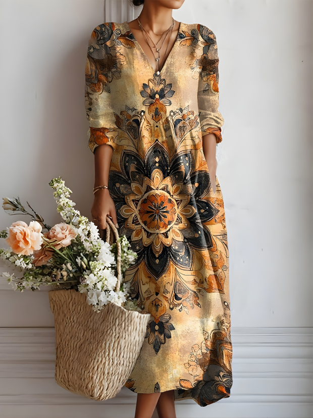 A woman wearing the Artemis everyday comfort dress in a vibrant autumn floral pattern, standing casually outdoors.