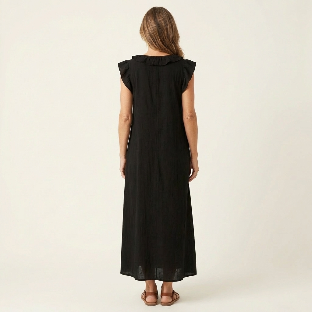 Model showcasing the yellow ruffle V-neck maxi dress, accessorised simply for an effortless summer look.