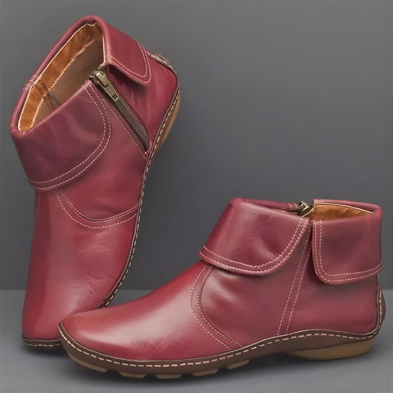 Front view of a pair of black Audra orthopaedic waterproof boots with a side zipper, showcasing the textured material.