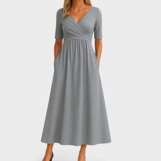 Front view of the Audrey versatile midi dress in a classic black color, showcasing its elegant V-neck and relaxed fit.