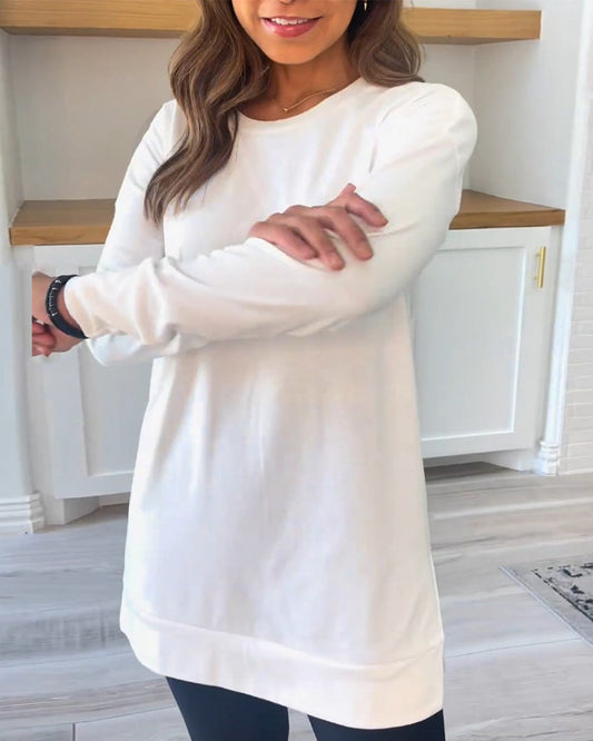 Front view of a white Aurelia long sleeve top, showcasing its soft texture and classic round neckline on a model.