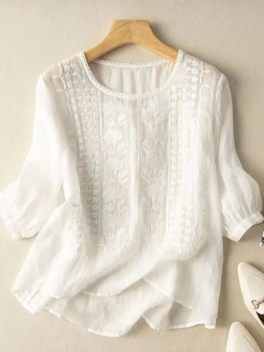 Front view of the white Aurelia blouse, showcasing its relaxed fit and rounded neckline.