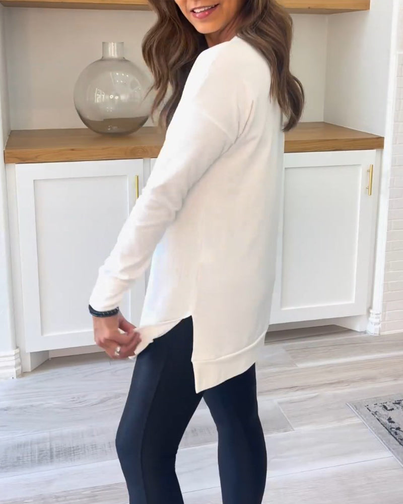 Side profile of a woman wearing the pink Aurelia long sleeve top, highlighting the comfortable regular fit and subtle side slit.