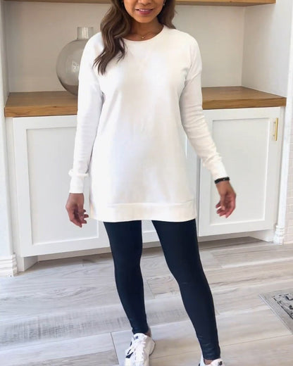 A model wearing the white Aurelia long sleeve top, paired with jeans, demonstrating a casual yet polished everyday look.
