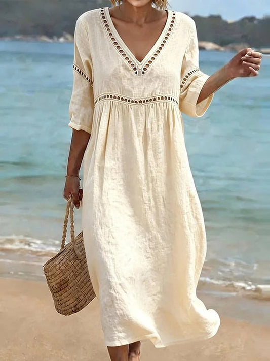 Front view of the Aurelie embroidered midi dress in a soft beige color, showcasing the V-neck and mid-sleeves.