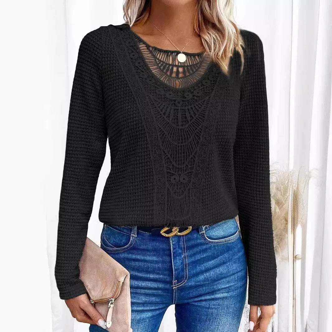 Side profile of a woman wearing a navy blue crochet detail jumper, highlighting the relaxed fit and long sleeves.