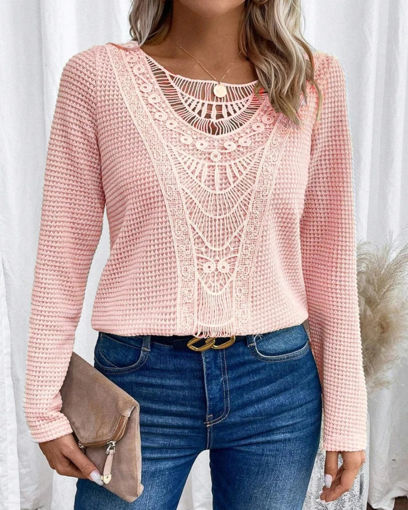 Close-up detail of the unique crochet pattern on the chest of the beige textured knit jumper.