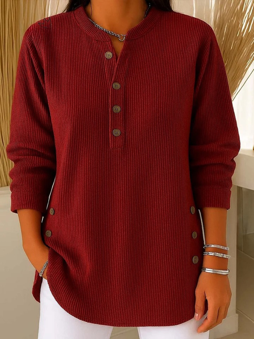 Close-up detail of the Henley button placket on the white Bronte ribbed long sleeve top.