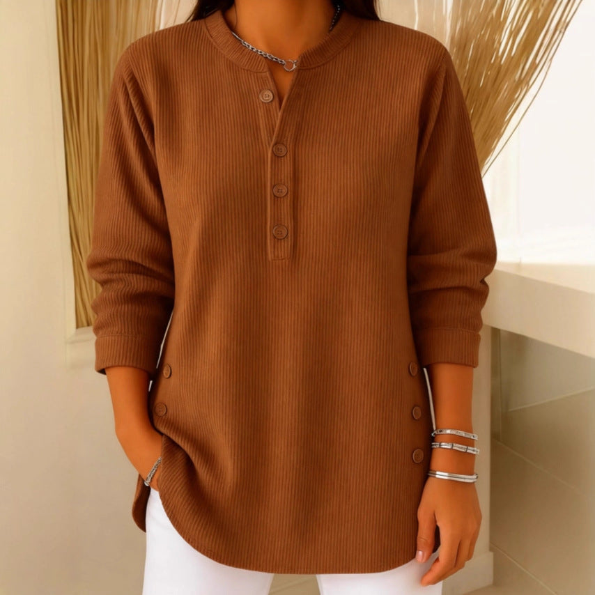 Lifestyle image of a woman pairing the pink Bronte ribbed long sleeve top with jeans for a casual look.