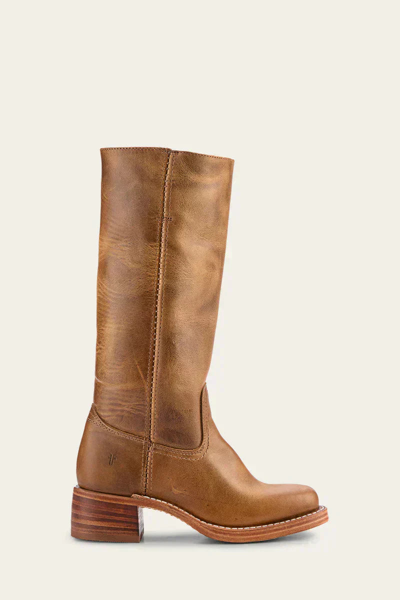 A pair of black Calista mid-calf boots styled with a long skirt, demonstrating their elegant fit.
