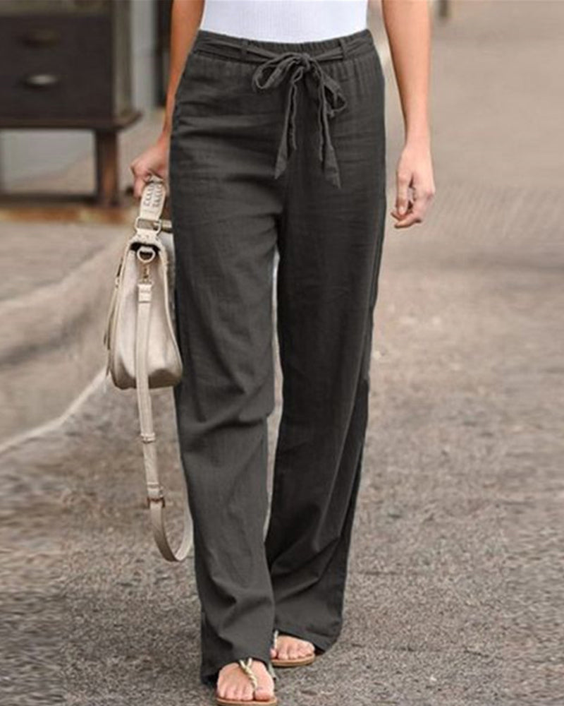 Rear view of the Calla straight-leg trousers in a blue hue, demonstrating the relaxed drape and full length.