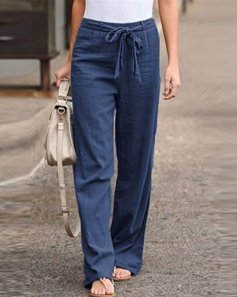Lifestyle shot of Calla relaxed trousers paired with a casual top, perfect for a spring day out.