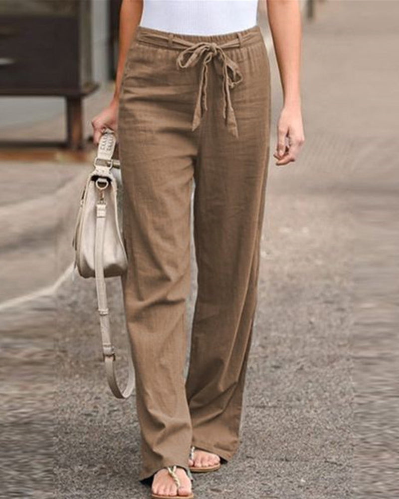 Folded Calla straight-leg trousers in a green colour, displaying the soft fabric and simple design.