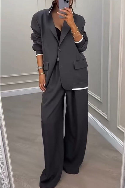 Side profile of a model wearing the Calliope ribbed colour block set, highlighting the loose fit and ankle-length trousers.