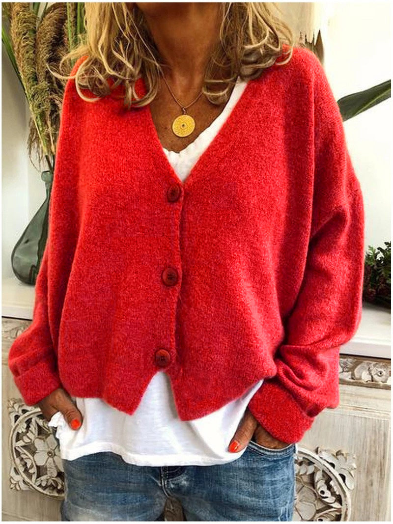 Front view of a red Calypso V-neck button cardigan, unbuttoned, showing its flow and drape.