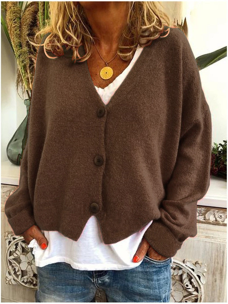 Brown Calypso V-neck button cardigan, folded neatly to display its compact and travel-friendly nature.