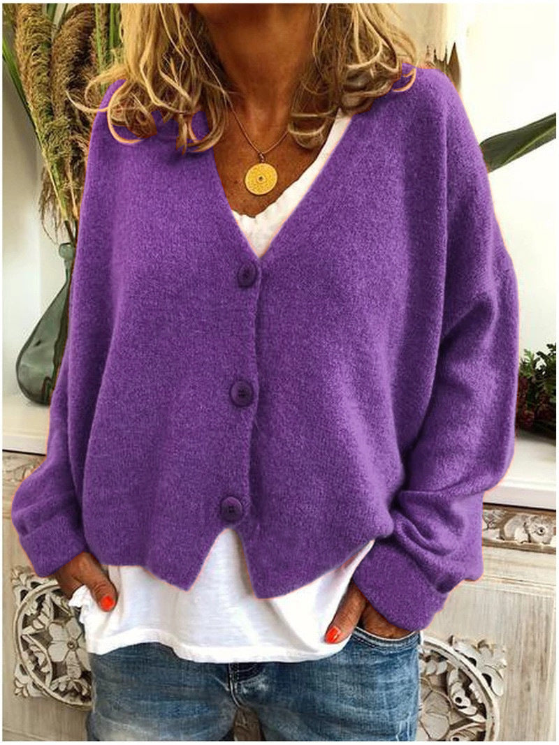 Flat lay of a purple Calypso V-neck button cardigan, showcasing its full design and colour consistency.