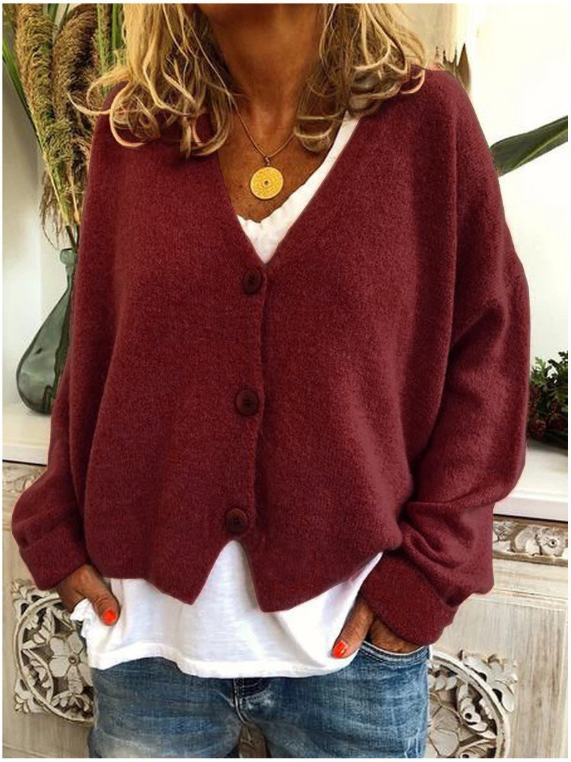 Close-up of the knit surface on a dark red Calypso cardigan, highlighting the quality and softness of the fabric.