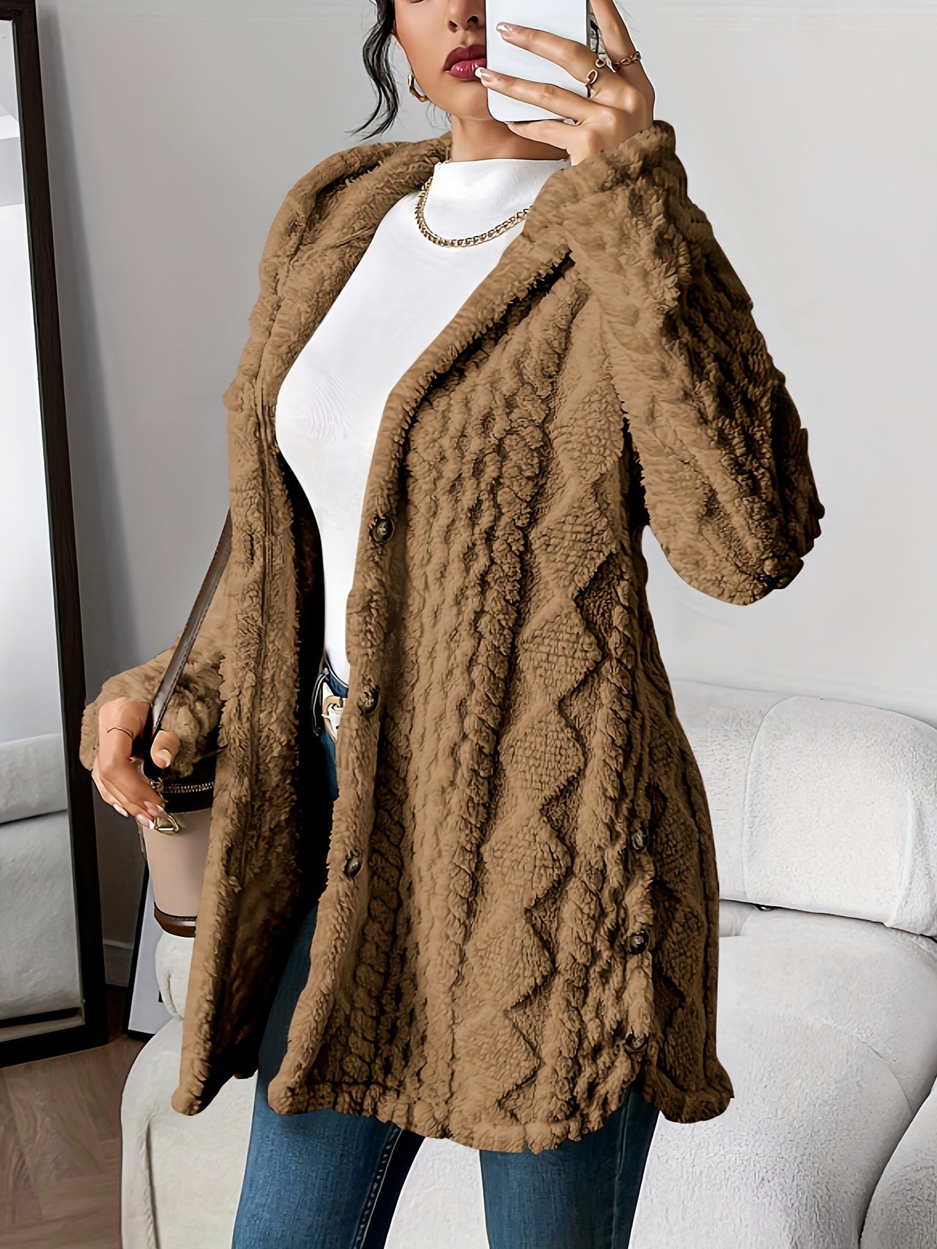 Back view of the grey hooded knitted cardigan, showing the continuous flow of the hood and hem.