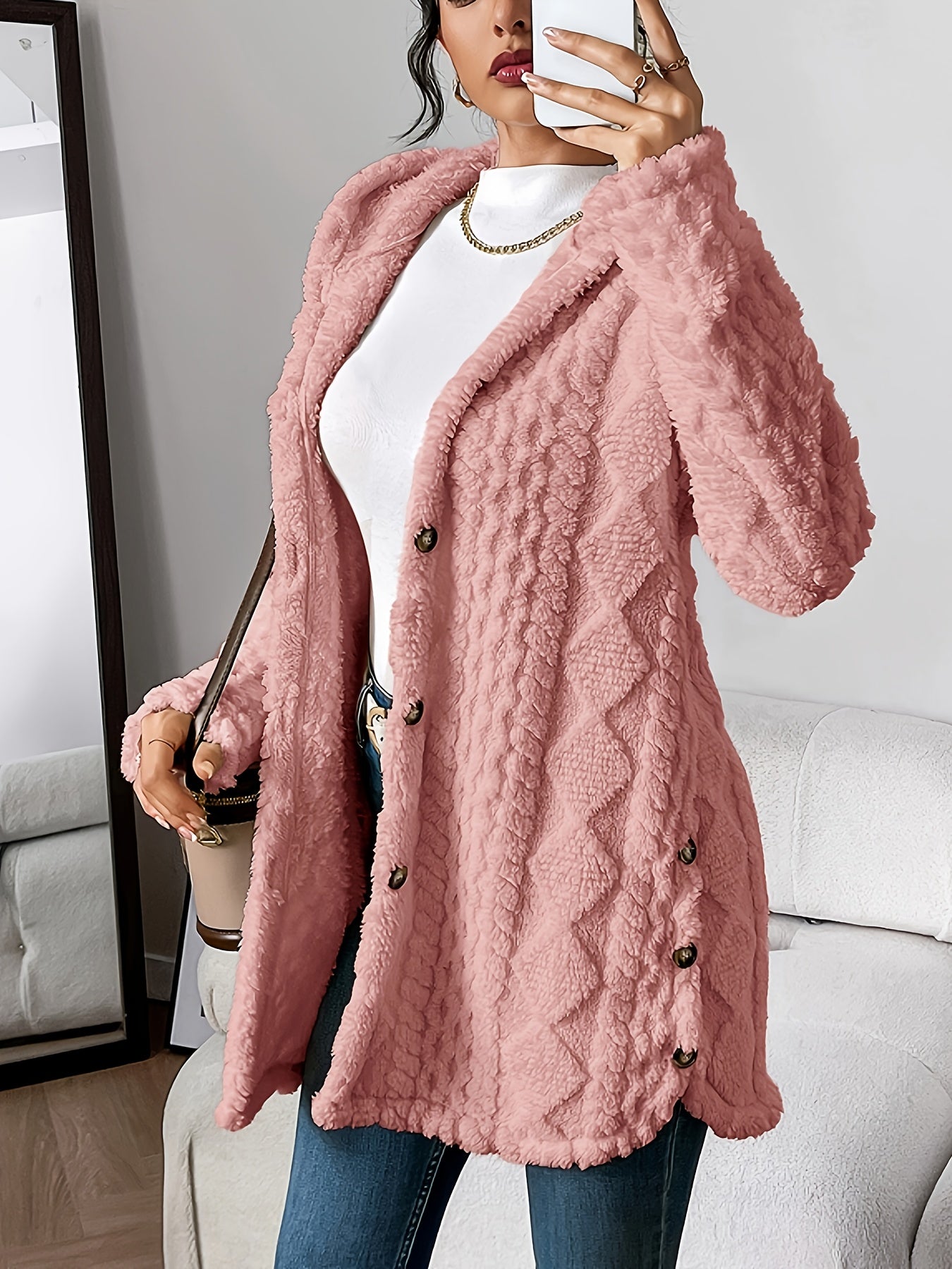 Close-up of the cuff and sleeve detail of the pink hooded knitted cardigan, showing the knit finish.