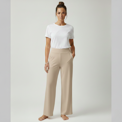 Woman in an apricot Clara comfortable stretch trouser, showcasing a soft, warm hue.