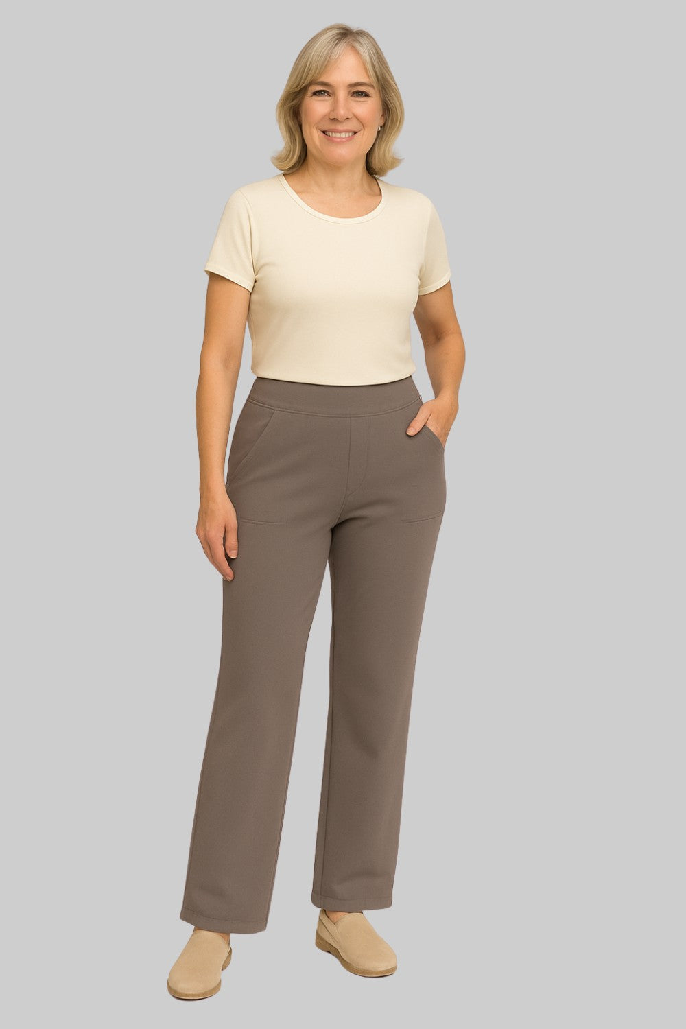 Side profile of a woman showcasing the relaxed fit of the taupe Clara comfortable stretch trouser.