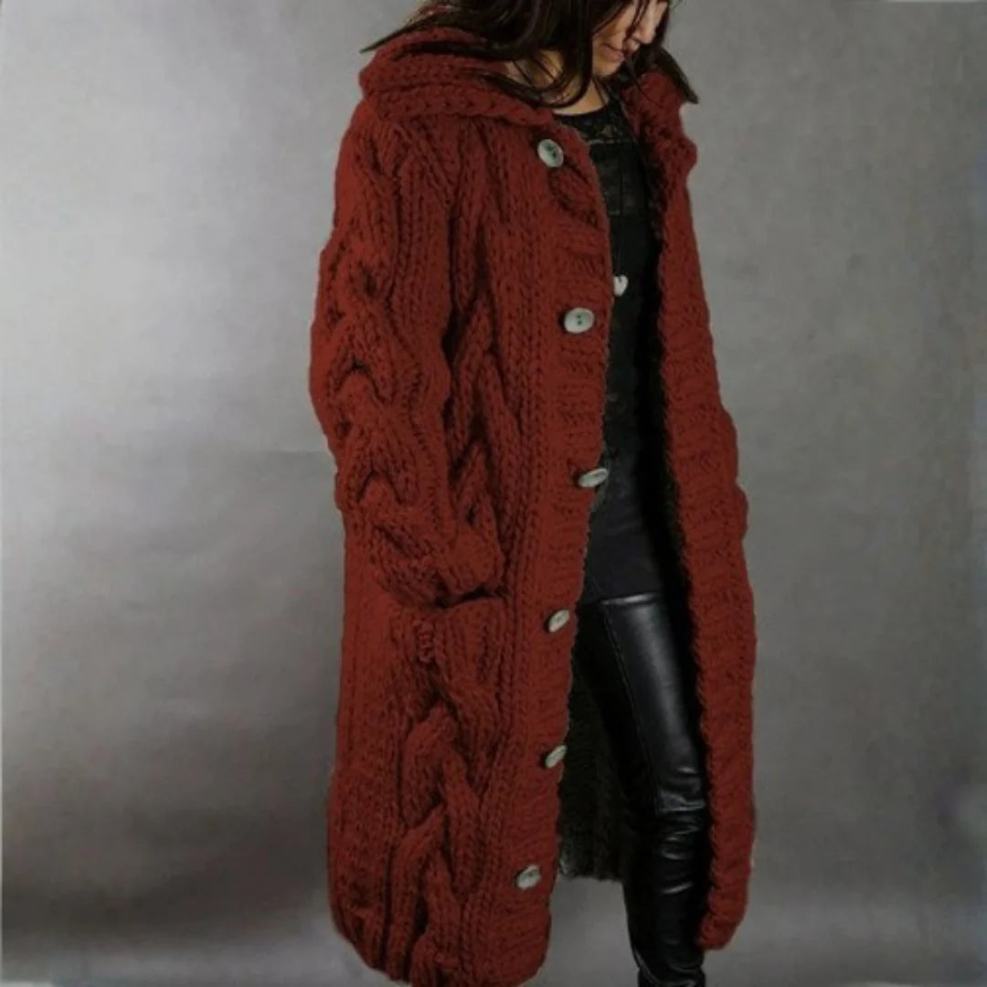 Close-up detail of the intricate cable knit pattern on the fabric of the high-quality longline coat.