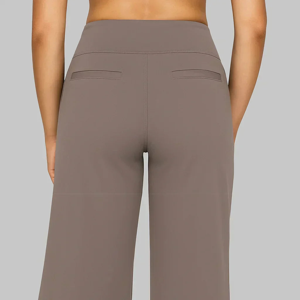 Back view of a woman demonstrating the flattering silhouette of the taupe Clara comfortable stretch trouser.
