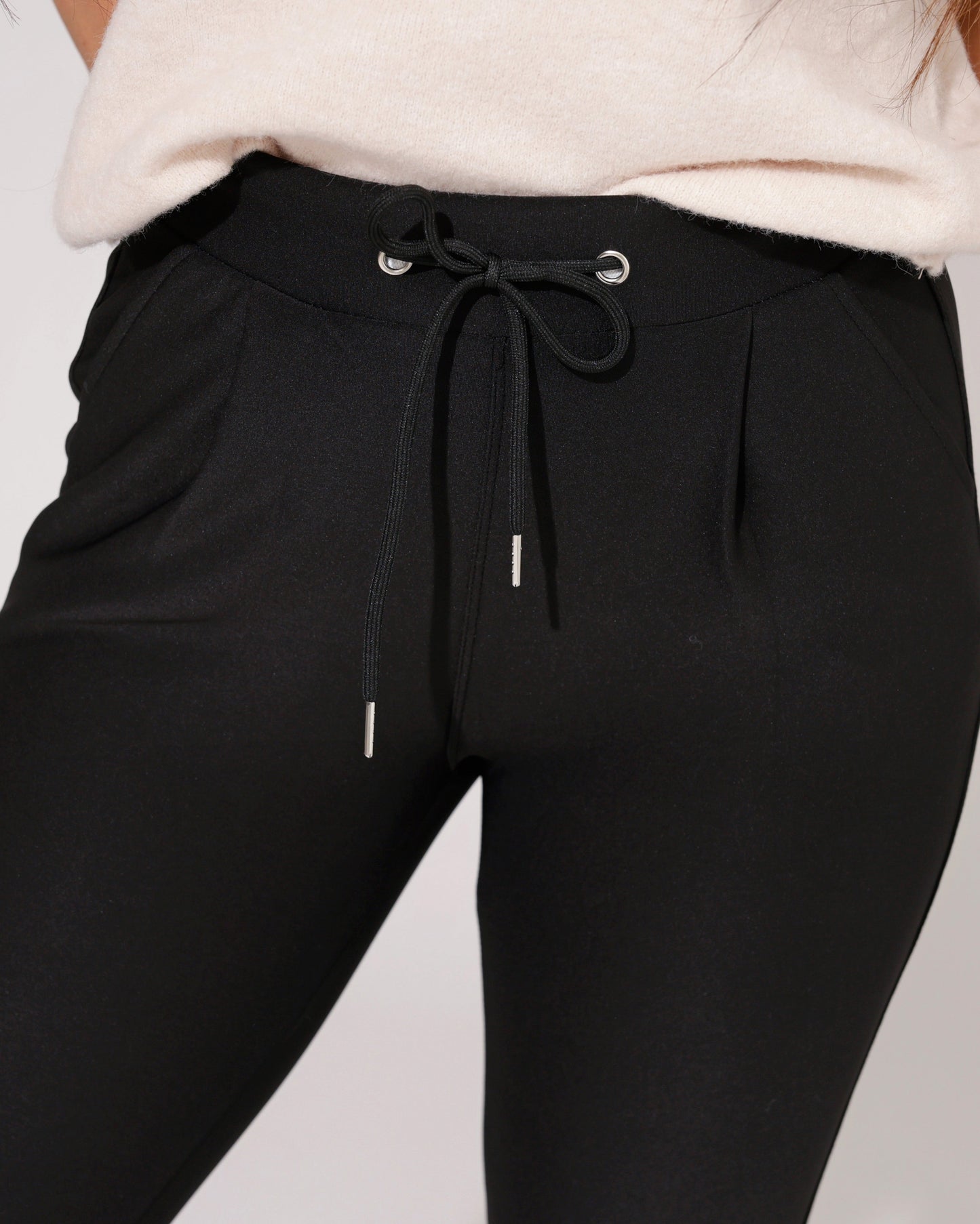 Lifestyle shot of the black comfort skinny trousers paired with a stylish top, suitable for various occasions.